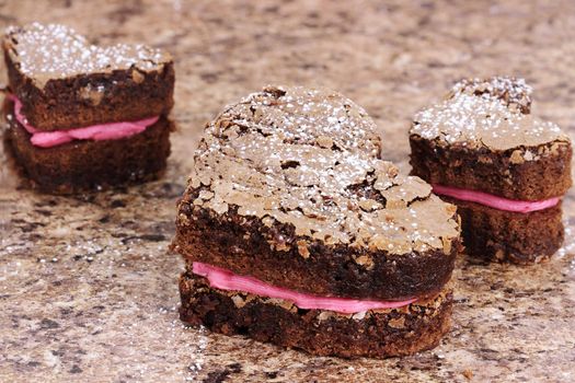 Three delicious heart shaped brownies piped with strawberry or raspberry flavored frosting.