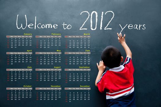 A boy is writing the 2012 calendar