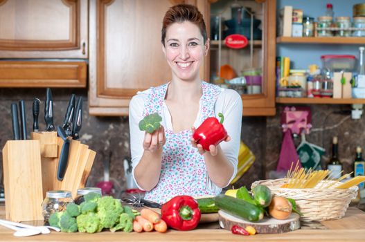 beautiful housewife cooking vegetables in the kitchen