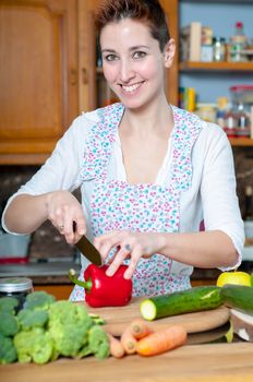 beautiful housewife cooking vegetables in the kitchen