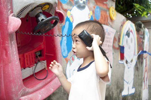 Youth children listen to the phone toys