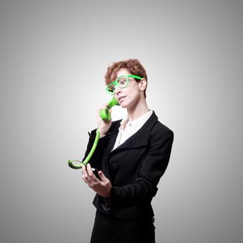 business woman with phone on gray background