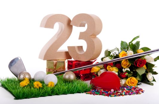 Roses, a golf club and golf balls on an artificial peace of grass to be used as a birthday card
