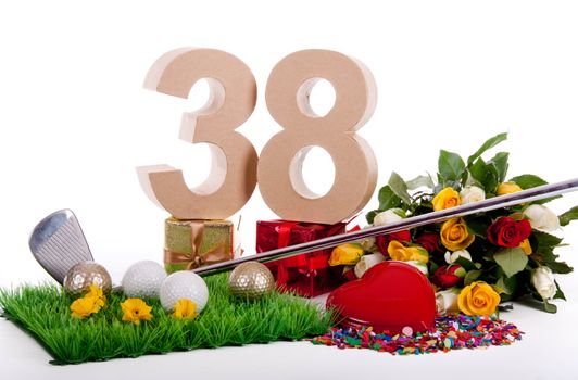 Roses, a golf club and golf balls on an artificial peace of grass to be used as a birthday card