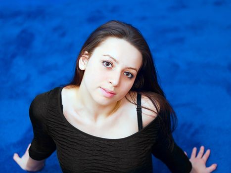 portrait of a young girl on blue background