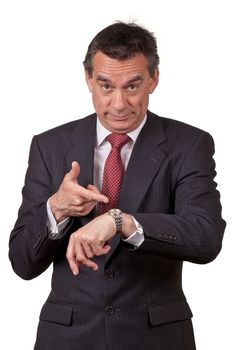Attractive Middle Age Business Man in Suit Pointing at Watch Angry about Time Isolated
