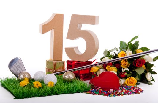 Roses, a golf club and golf balls on an artificial peace of grass to be used as a birthday card