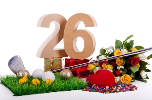 Roses, a golf club and golf balls on an artificial peace of grass to be used as a birthday card