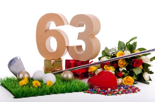 Roses, a golf club and golf balls on an artificial peace of grass to be used as a birthday card