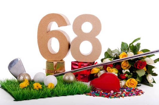 Roses, a golf club and golf balls on an artificial peace of grass to be used as a birthday card