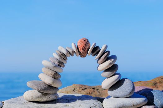 Red stone in the center arch of pebbles