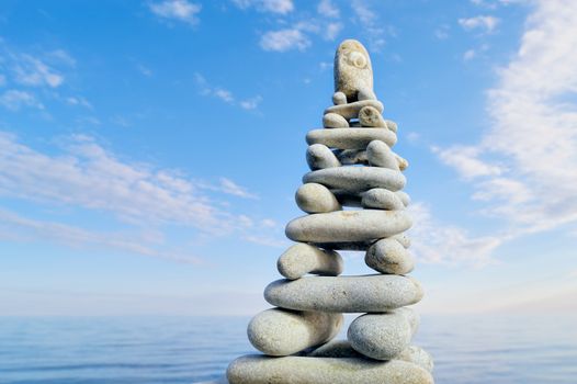 Stack of zen stones on a sky and sea background