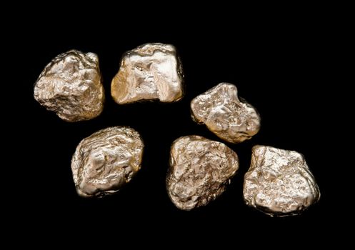 gold nuggets on a black background. closeup.