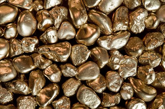 shiny gold nuggets background. closeup.