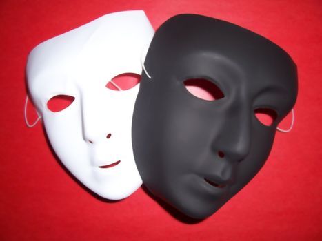 Isolated black and white masks on a red background