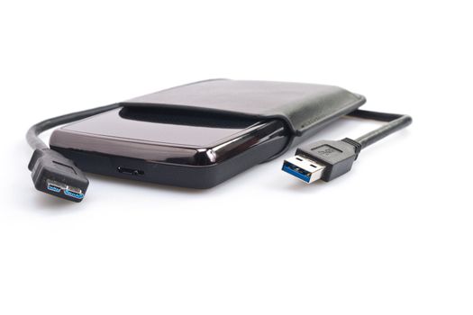 a portable harddisk in  soft leather case and USB cable on white background