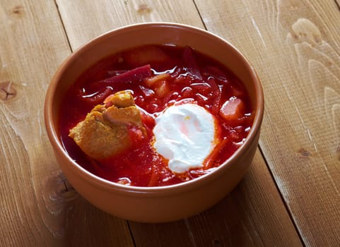 ukrainian and russian red-beet soup (borscht) with garlic and sour cream