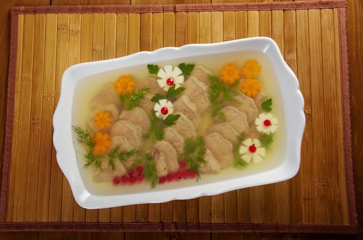 Aspic from meat decorated with egg, carrot,