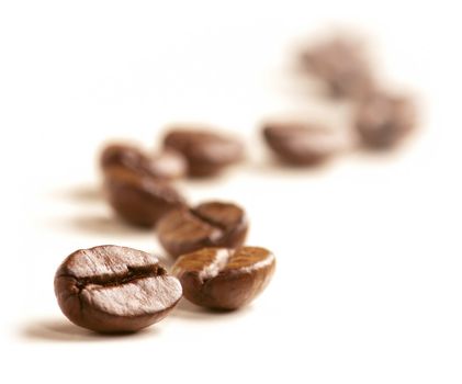 Coffee Beans draw a zigzag line isolated on white. Soft focus.