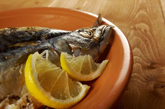 Mackerel on a grill. Fish prepared  with a lemon
