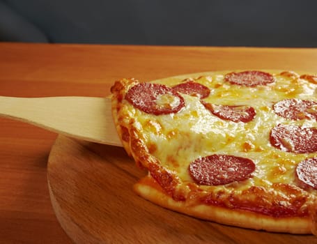 homemade pizza  Pepperoni .taking slice of pizza,melted cheese dripping.