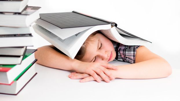 girl lying with a book on her head with closed eyes tired