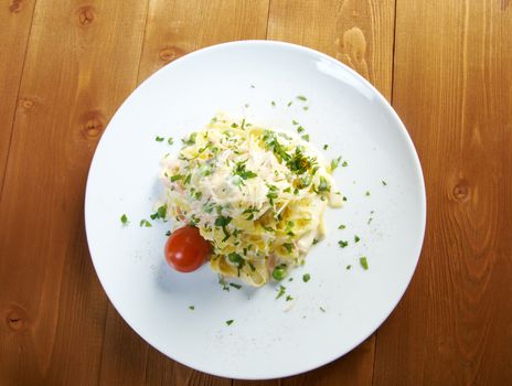 pasta Fettuccine Alfredo with cherry tomato, ham. close-up