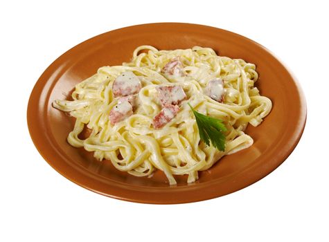 pasta Fettuccine Alfredo with sausage. close-up isolated