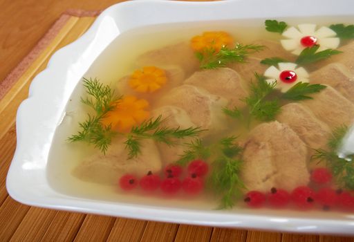 Aspic from meat decorated with egg, carrot,