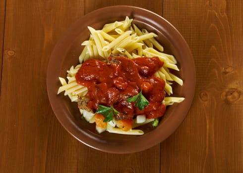  pasta with tomato beef sauce  on wooden table