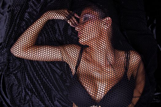 Attractive Woman Traped In Black Fishnet