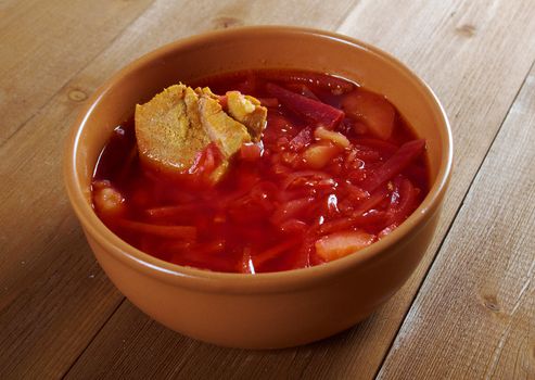 ukrainian and russian red-beet soup (borscht) with garlic and sour cream