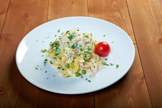 pasta Fettuccine Alfredo with cherry tomato, ham. close-up