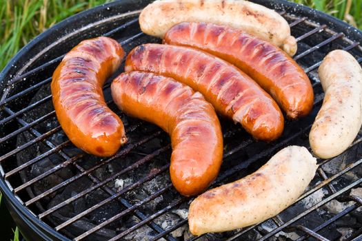 Grilled sliced sausages, tasty picnic food, barbecue