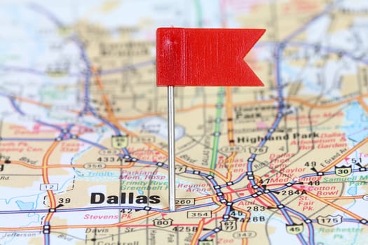 Dallas, Texas. Red flag pin on an old map showing travel destination.