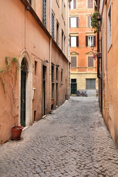 Old town cobbled street and Mediterranean architecture in Parione district of Rome, Italy