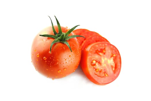 fresh tomatoes and tomatoes slices with green leaves on white background