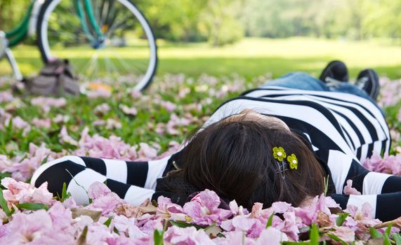 Asian woman sleeping on the grass