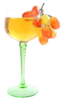 Wineglass with a drink and a grapes.