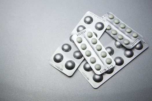 Silver Pills On Metal Table Background, copy space