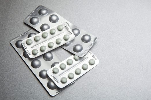 Silver Pills On Metal Table Background, copy space