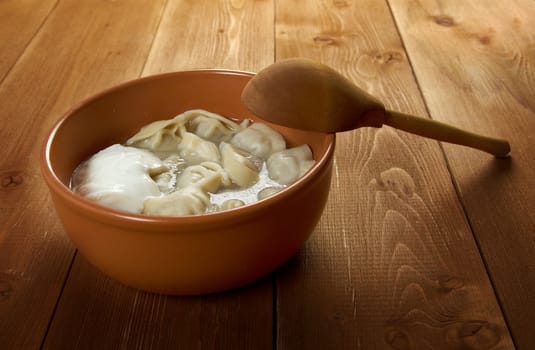 Traditional Russian food "pelmeni".Meat dumplings  with sour cream