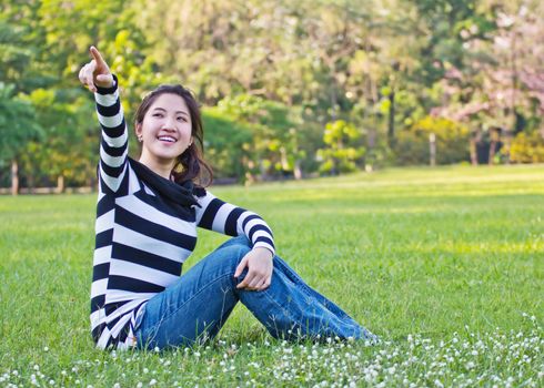 Asian woman pointing the tree