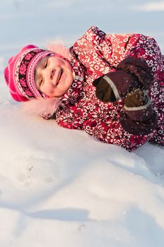 Baby lays on snow and laugh a lot