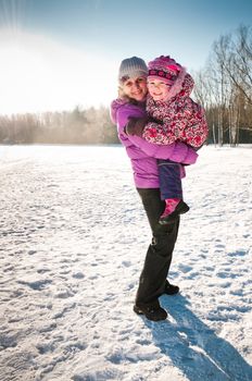 Mother hugs her little daughter, they are happy