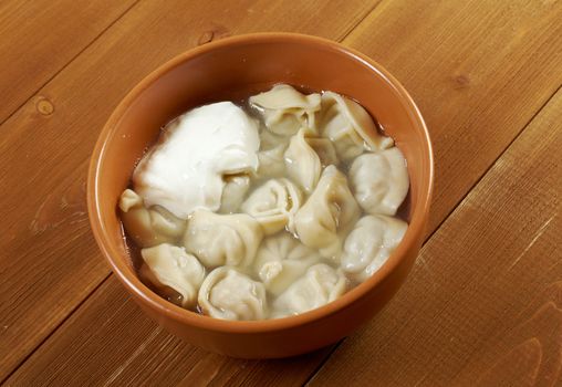 Traditional Russian food "pelmeni".Meat dumplings  with sour cream