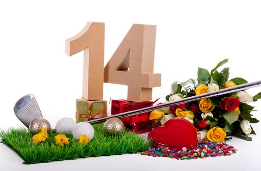 Roses, a golf club and golf balls on an artificial peace of grass to be used as a birthday card