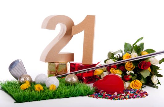 Roses, a golf club and golf balls on an artificial peace of grass to be used as a birthday card