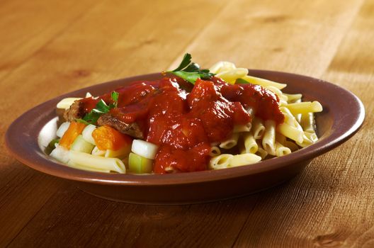  pasta with tomato beef sauce  on wooden table