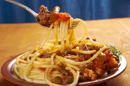  pasta with  beef ,vegetable  tomato sauce  on wooden table